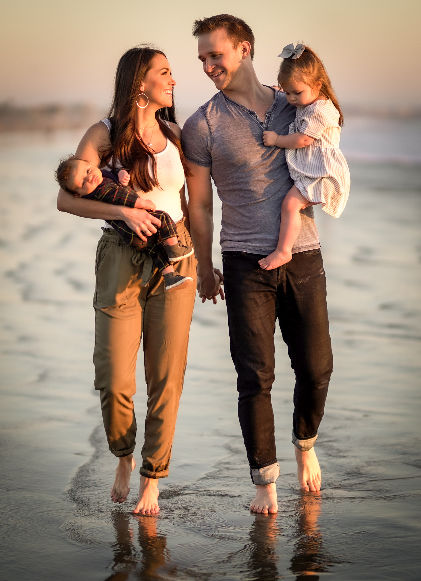 Family walking together at the beach at golden hour
